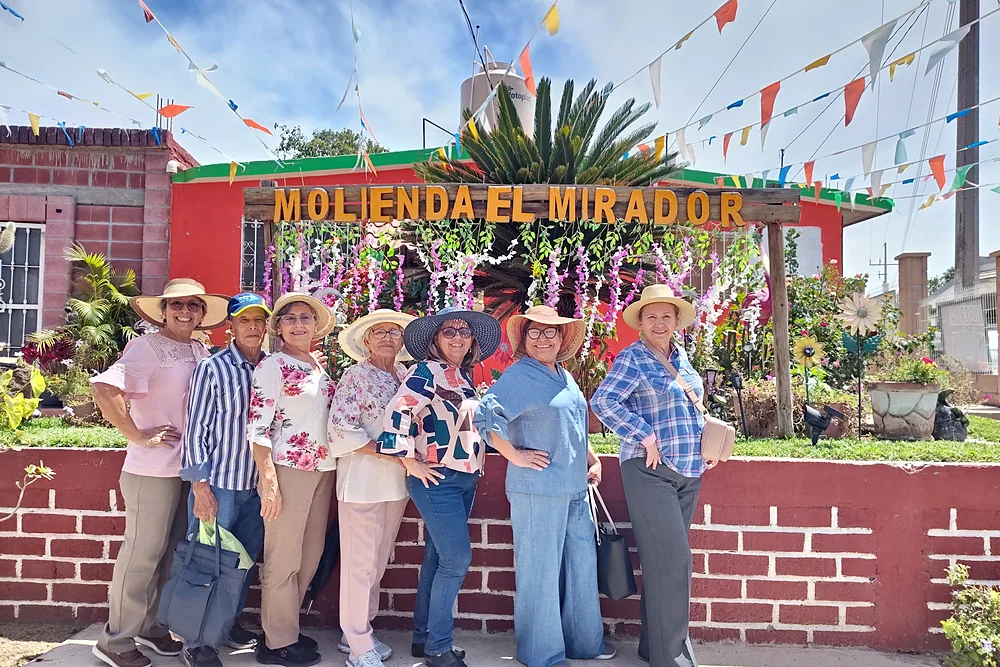 Grupo de viajeros posando frente a la Molienda El Mirador